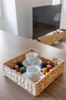 a wooden tray with cups and saucers on a table at LES PIEDS DANS LE VIEUX PORT in Marseille