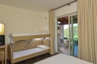 A bed or beds in a room at Castelsardo Resort Village