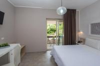 A bed or beds in a room at Castelsardo Resort Village