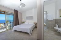 A bed or beds in a room at Castelsardo Resort Village