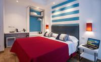 A bed or beds in a room at Hotel Angelina