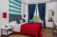 A bed or beds in a room at Hotel Angelina