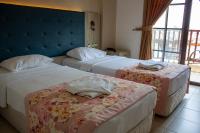 A bed or beds in a room at Hamle Hotel
