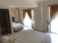 A bed or beds in a room at Hamle Hotel