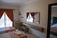A bed or beds in a room at Hamle Hotel