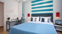 A bed or beds in a room at Hotel Angelina