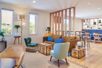 a living room with a couch and chairs at Kyriad Paris Sud Les Ulis Courtaboeuf in Les Ulis