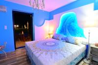 a bedroom with a bed with a blue and pink wall at Alisaxni Studios in Argassi