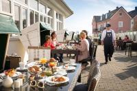 a group of people sitting at a table with food at TUI BLUE Sylt in Rantum