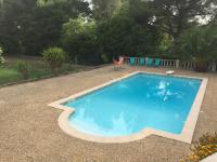 a large blue swimming pool sitting in a yard at Sur les pas de Pagnol in Aubagne