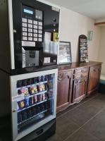 a refrigerator with food inside of it next to a counter at Hotel Atlantique in Mimizan-Plage