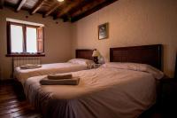 A bed or beds in a room at La Casa del Abuelo