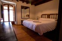 A bed or beds in a room at La Casa del Abuelo
