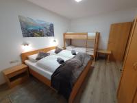 A bed or beds in a room at Glemmy Appartements inkl Sommercard