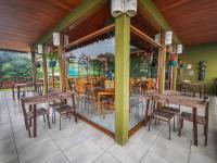 a group of tables and chairs in a restaurant at Ficus Sunset Suites in Monteverde Costa Rica