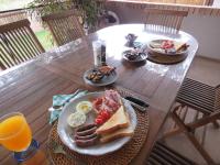 a table with a plate of breakfast food on it at Wild Dog Guest Lodge in Hoedspruit