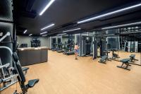 a woman in a gym with several machines at PARKROYAL COLLECTION Marina Bay, Singapore in Singapore
