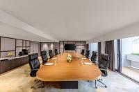 a conference room with a large wooden table and chairs at PARKROYAL COLLECTION Marina Bay, Singapore in Singapore