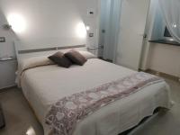 A bed or beds in a room at B&B Oplonti Resort