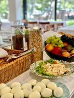 a table with a plate of food and a bowl of fruit at Family Resort Urania in Baška Voda
