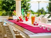 a table with a red table cloth and drinks on it at Holiday Home Villa Orhidea by Interhome in (( Marčići ))