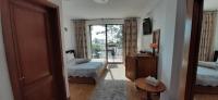 a bedroom with two beds and a door to a balcony at Vila pe plaja nr 9 in Saturn