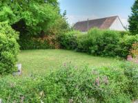a garden with a lawn with flowers and bushes at Gîte Montrésor, 4 pièces, 7 personnes - FR-1-381-72 in Montrésor