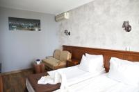 A bed or beds in a room at Petrov Family Hotel