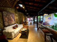 a living room with a couch and a table at Pousada Arte Urquijo in Paraty