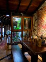 a room with a table with vases on it at Pousada Arte Urquijo in Paraty
