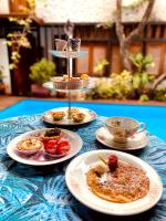a table with four plates of food on it at Pousada Arte Urquijo in Paraty