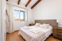 A bed or beds in a room at Casa Bruna - Binibeca Nou