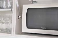 a white tv in a cabinet with wine glasses at Appartement neuf vue Marina étang Z&#39;abricot FDF in Fort-de-France