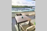 a table and chairs with a view of a marina at Appartement neuf vue Marina étang Z&#39;abricot FDF in Fort-de-France