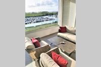 a living room with a view of a harbor at Appartement neuf vue Marina étang Z&#39;abricot FDF in Fort-de-France