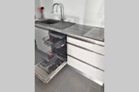 a kitchen with a sink and a dishwasher at Appartement neuf vue Marina étang Z&#39;abricot FDF in Fort-de-France