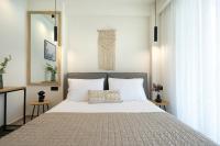 A bed or beds in a room at Aelia Seaside Luxury Suites