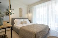A bed or beds in a room at Aelia Seaside Luxury Suites