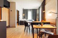 a living room with a table and a couch at harry&#39;s home Steyr hotel &amp; apartments in Steyr