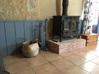 a fireplace in a room with a tiled floor at L&#39;Olivier in Puisseguin