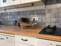 a kitchen counter with a basket on top of a stove at L&#39;Olivier in Puisseguin