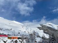 a train on a snow covered hill with a mountain at Logement 4&#47;6 personnes à la montagne avec piscine in Saint-Sorlin-dʼArves