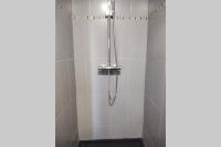 a shower with a shower head in a bathroom at le studio du fou in Mortagne-sur-Sèvre