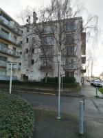 a tree on the side of a street in front of a building at Beau Studio proche front de mer , place de parking, fibre in Saint-Nazaire