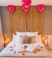 a bed with red hearts on top of it at Appart&amp;Spa Devosge in Dijon