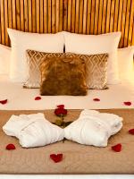 a bed with two towels and red hearts on it at Appart&amp;Spa Devosge in Dijon