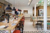 a dining room with wooden tables and chairs at Zoku Vienna in Vienna