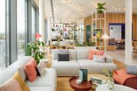 a living room with two couches and a table at Zoku Vienna in Vienna
