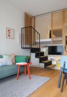 a living room with a green couch and a table at Zoku Vienna in Vienna