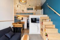 a living room with a couch and a kitchen and stairs at DIFY Joseph Bonnet - Croix Rousse in Lyon